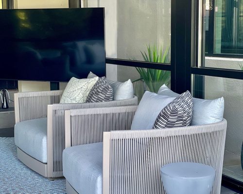 Sun room designed by Ike Kligerman Barkley and furnished by Portside Luxury featuring pieces by Harbour Outdoor.