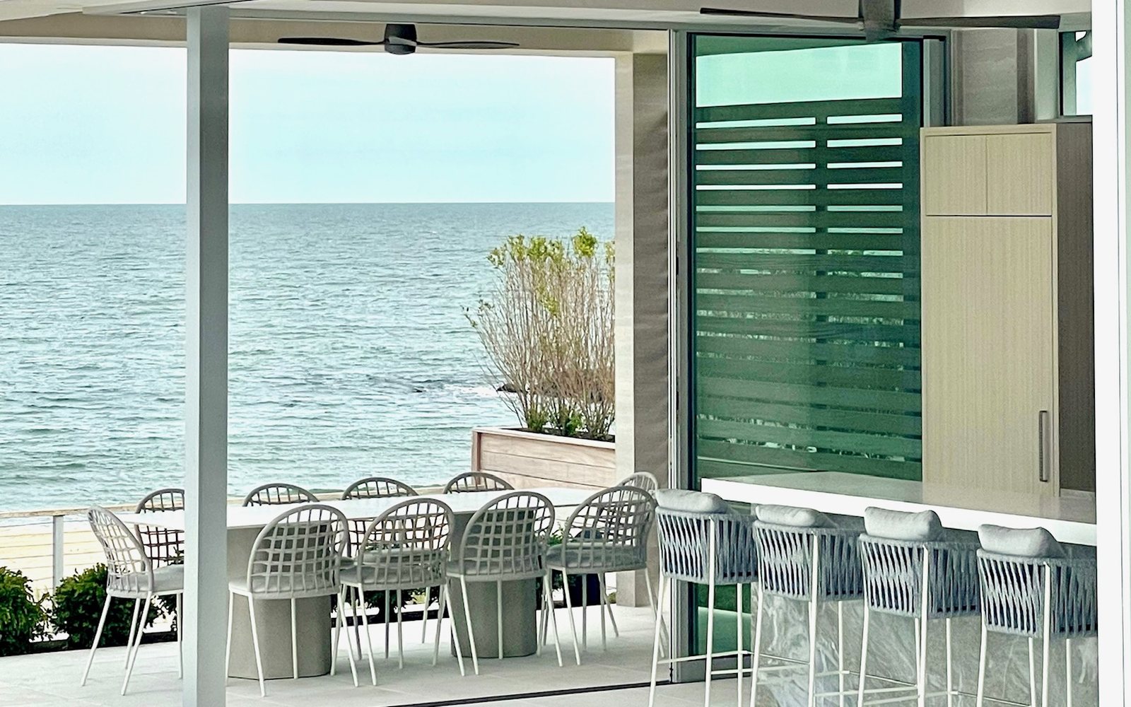Oceanfront Portside Luxury outdoor terrace with dining and bar seating
