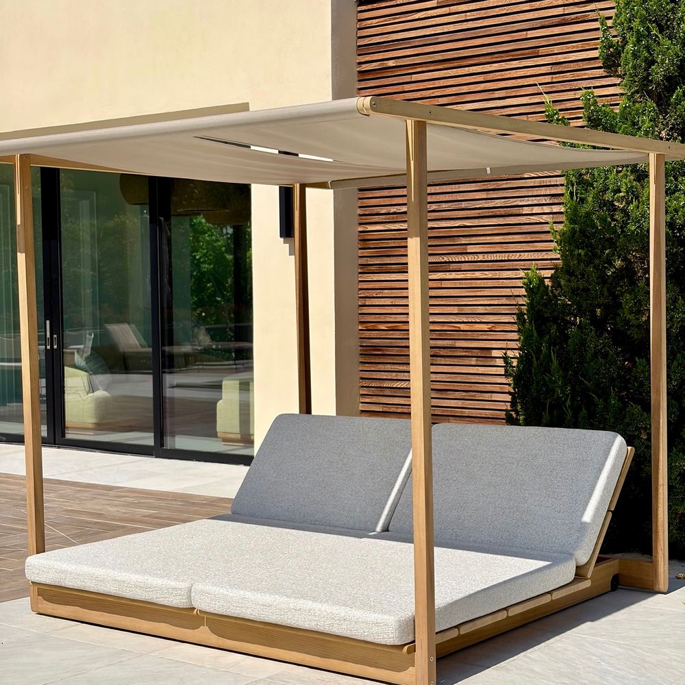 Canopy Daybed. A teak daybed against the timber screen.
