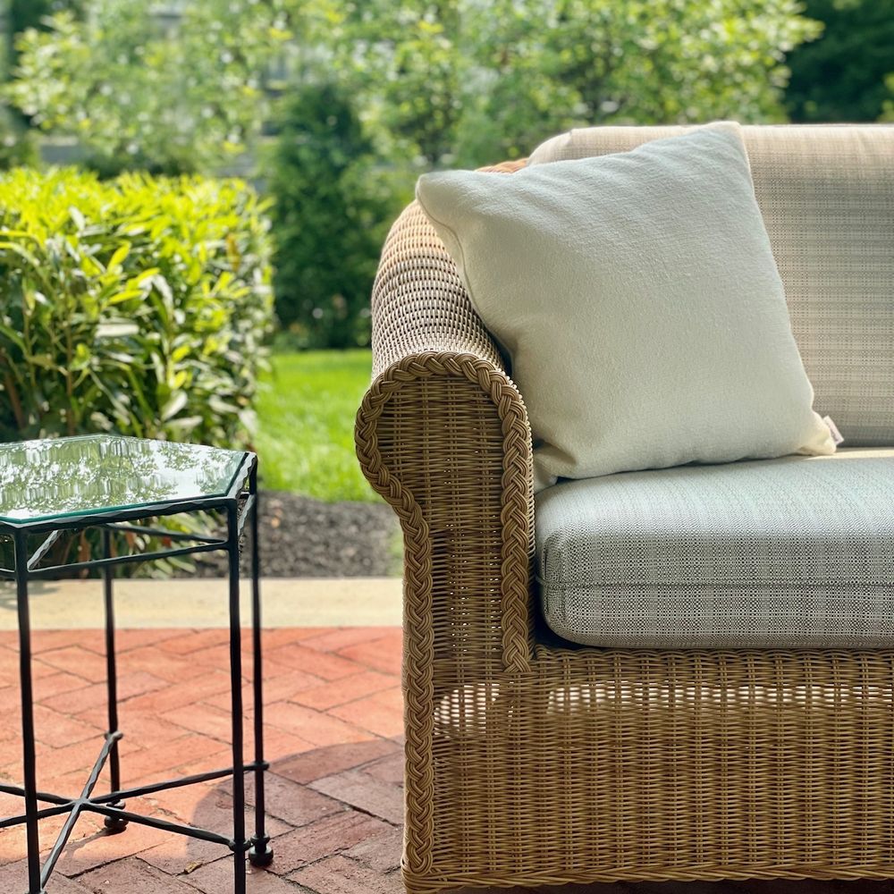 Woven Armchair. A woven armchair on the brick terrace.